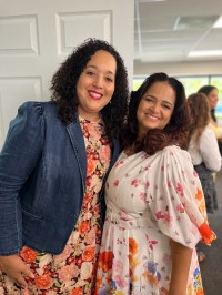two women pose